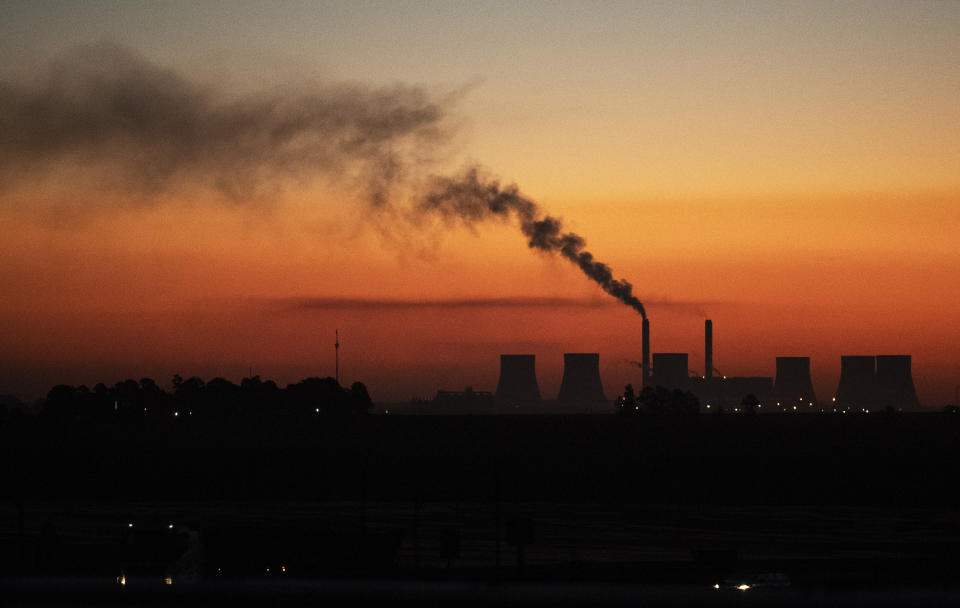 FILE - A coal-fired power station in Witbank, South Africa , Monday, Oct. 11, 2021. South Africans are struggling in the dark to cope with increased power cuts that have hit households and businesses across the country. The rolling power cuts have been experienced for years but this week the country’s state-owned power utility Eskom extended them so that some residents and businesses have gone without power for more than 9 hours a day. (AP Photo/Themba Hadebe, File)