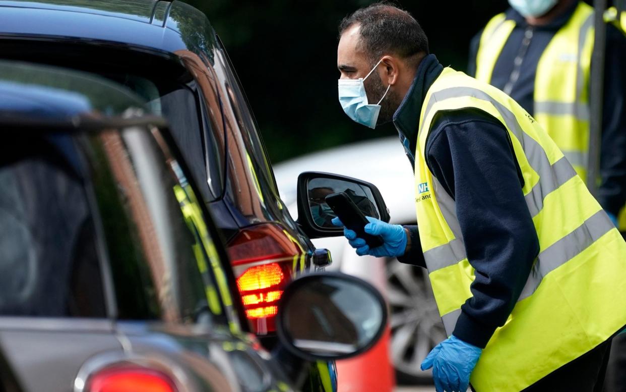 A member of staff works on behalf of NHS Test and Trace at a coronavirus testing centre in Staffordshire last month - Christopher Furlong/Getty Images Europe