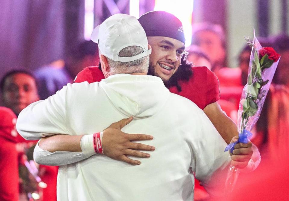 Fresno State coach Jeff Tedford hugs senior linebacker Levelle Bailey as he is introduced on senior night before the Bulldogs’ game with New Mexico at Valley Children’s Stadium on Saturday, Nov. 18, 2023.