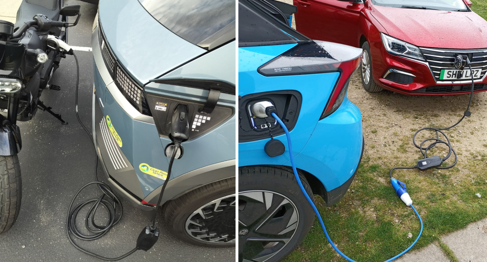 A motorbike charges from a van on the left, beside another EV charging a third a on the right. 