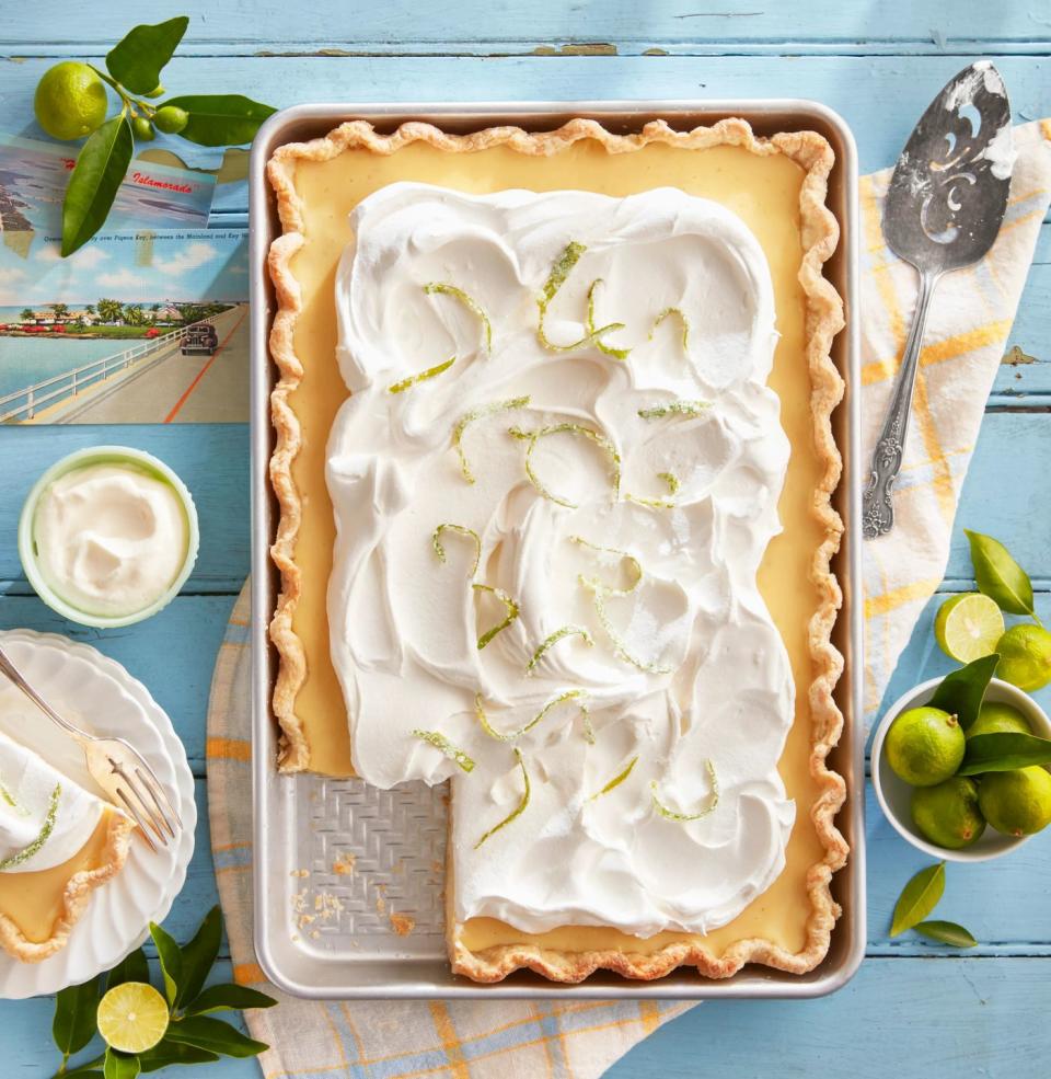 key lime slab pie with candied lime zest in a tray on a blue table