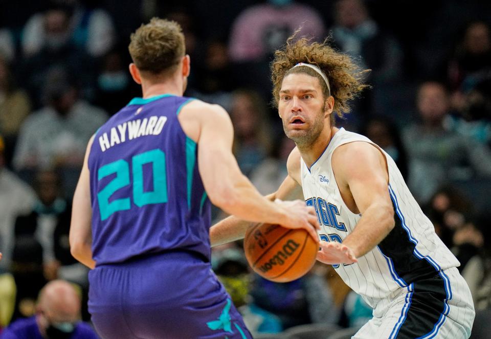 Orlando Magic center Robin Lopez (33) guards Charlotte Hornets forward Gordon Hayward (20) during the first half of an NBA basketball game on Friday, Jan. 14, 2022, in Charlotte, N.C. (AP Photo/Rusty Jones)