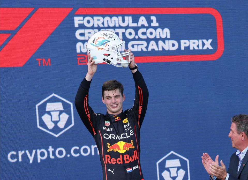 Race winner Red Bull driver Max Verstappen of the Netherlands, lift his gifted signed football helmet given to him by Dan Marino after winning the inaugural Formula One Miami Grand Prix auto race at Miami International Autodrome on Sunday, May 8, 2022 in Miami Gardens, Florida.