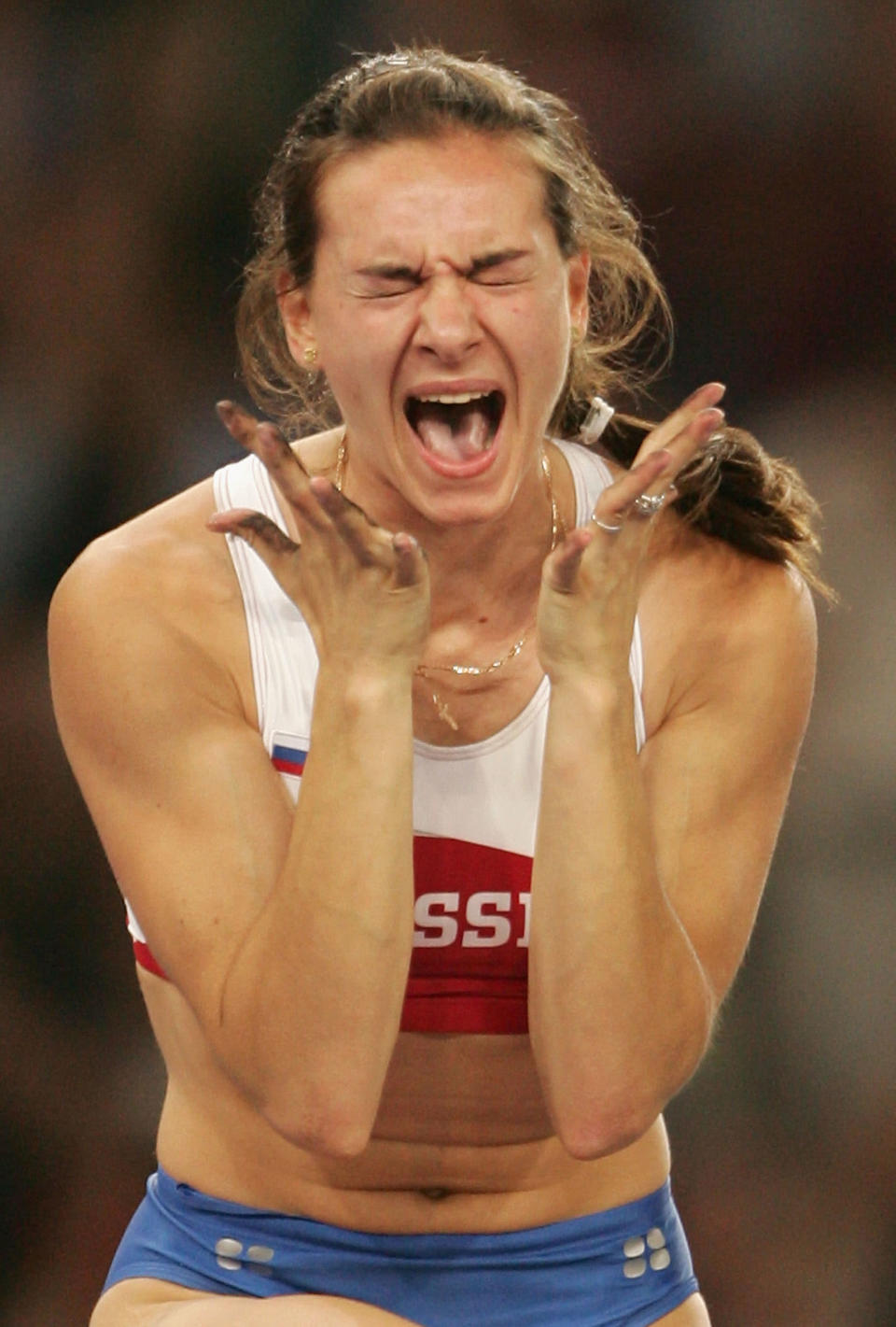 ATHENS - AUGUST 24: Yelena Isinbayeva of Russia celebrates after she completed a world record attempt in the women's pole vault final on August 24, 2004 during the Athens 2004 Summer Olympic Games at the Olympic Stadium in the Sports Complex in Athens, Greece. Isinbayeva of Russia broke the world record in the women's pole vault Tuesday with a vault of 16 feet, 1 1/4 inches (4.91 meters). (Photo by Mark Dadswell/Getty Images)