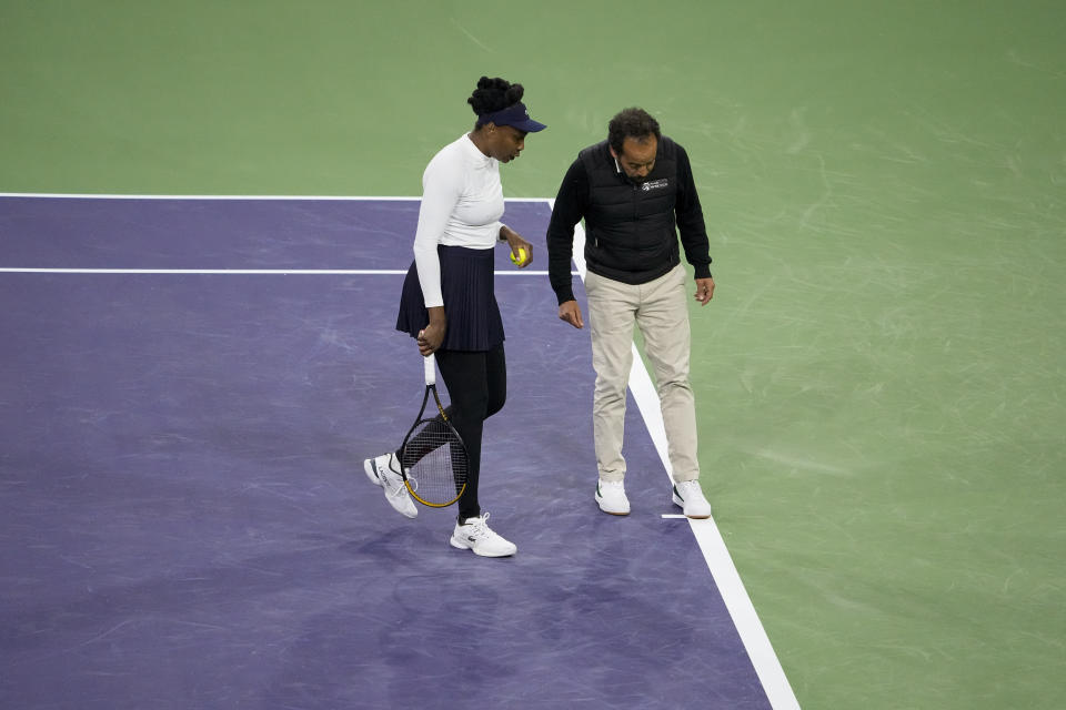 Venus Williams, of the United States, left, talks to chair umpire Kader Nouni about the rain delay during her match against Nao Hibino, of Japan, at the BNP Paribas Open tennis tournament Wednesday, March 6, 2024, in Indian Wells, Calif. (AP Photo/Mark J. Terrill)