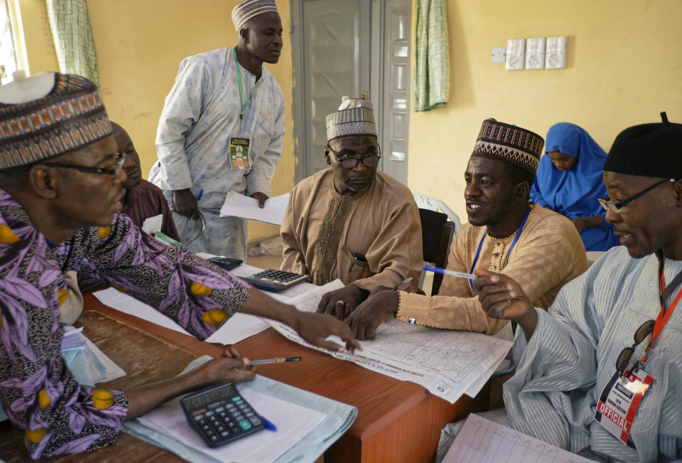 Electoral officials compile voting results at a collation center in Kano, northern Nigeria Sunday, Feb. 24, 2019. Vote counting continued Sunday as Nigerians awaited the outcome of a presidential poll seen as a tight race between the president and a former vice president. (AP Photo/Ben Curtis)