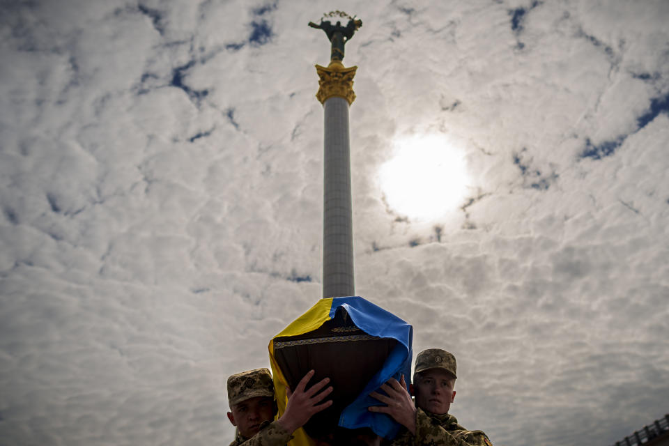 Ukrainian servicemen carry the coffin of their fallen fellow Vadym Popelniuk, born in 1991, during a religious service in Independence Square in Kyiv, Ukraine, Friday, April 5, 2024. (AP Photo/Vadim Ghirda)