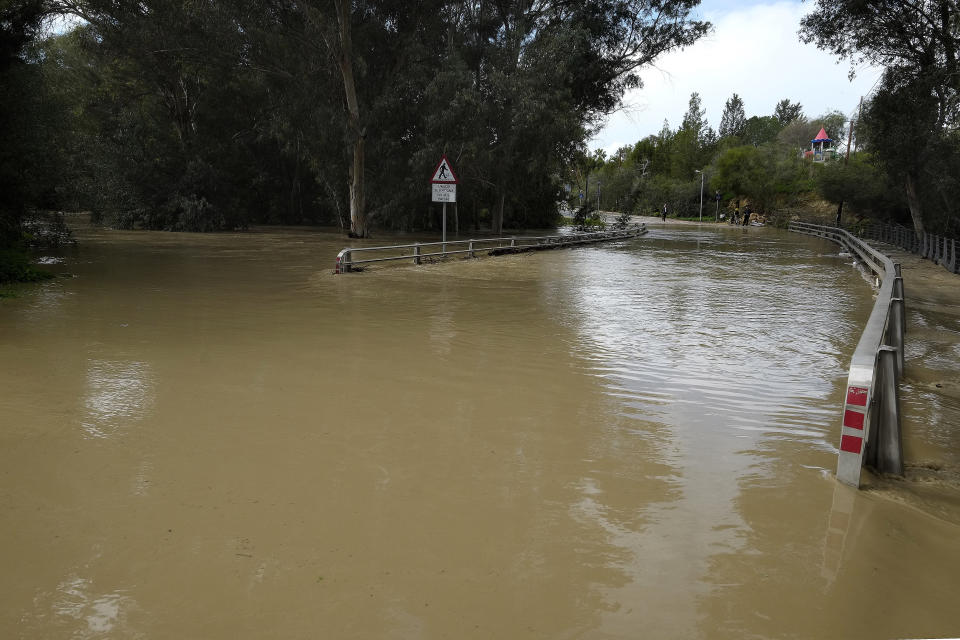 Pedieos River floods a main road after heavy rainfall overnight, in capital Nicosia, Cyprus, Wednesday Jan. 16, 2019. Cyprus is in the grip of a mid-winter storm bringing heavy rains, low temperatures and snow in the Troodos mountain range. (AP Photo/Petros Karadjias)