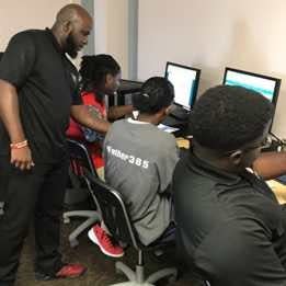 An instructor South Carolina Center for Fathers and Families helps students during a program.