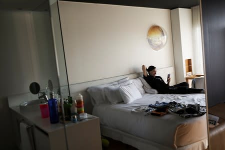 Miriam Gutierrez "La Reina", 36, talks to her children in her hotel room as she waits to fight Bianka Nagy in Barcelona