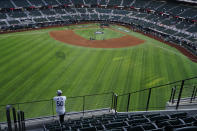 A fan watches batting practice from center field before Game 1 of the baseball World Series between the Los Angeles Dodgers and the Tampa Bay Rays Tuesday, Oct. 20, 2020, in Arlington, Texas.(AP Photo/Sue Ogrocki)