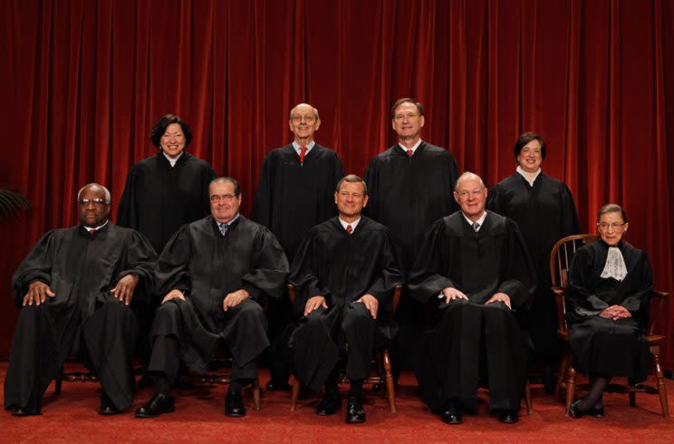 U.S. Supreme Court members (first row L-R) Associate Justice Clarence Thomas, Associate Justice Antonin Scalia, Chief Justice John Roberts, Associate Justice Anthony Kennedy, Associate Justice Ruth Bader Ginsburg, (back row L-R) Associate Justice Sonia Sotomayor, Associate Justice Stephen Breyer, Associate Justice Samuel Alito and Associate Justice Elena Kagan pose for photographs in the East Conference Room at the Supreme Court building October 8, 2010 in Washington, DC. This is the first time in history that three women are simultaneously serving on the court. (Photo: Getty Images)