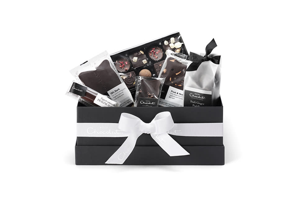 <p>Vegan foodies, rejoice! This festive season, Hotel Chocolat is selling an All Dark Hamper Collection which boasts a fruit and nut chocolate slab, hazelnut log and ginger puddles – all wrapped up in a chic bow. <em><a rel="nofollow noopener" href="https://www.hotelchocolat.com/uk/the-all-dark-collection.html#start=1?utm_source=rakuten&utm_medium=referral&utm_campaign=2116208:Skimlinks.com&utm_content=10&utm_term=UKNetwork&ranMID=43303&ranEAID=TnL5HPStwNw&ranSiteID=TnL5HPStwNw-DNkZ.ib1PgSxbRiqYYhaTQ" target="_blank" data-ylk="slk:Hotel Chocolat" class="link ">Hotel Chocolat</a>, £27.50</em> </p>