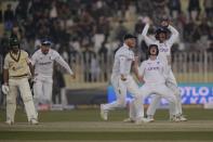 England's players celebrate after the dismissal of Pakistan's Naseem Shah, left, during the fifth day of the first test cricket match between Pakistan and England, in Rawalpindi, Pakistan, Monday, Dec. 5, 2022. (AP Photo/Anjum Naveed)