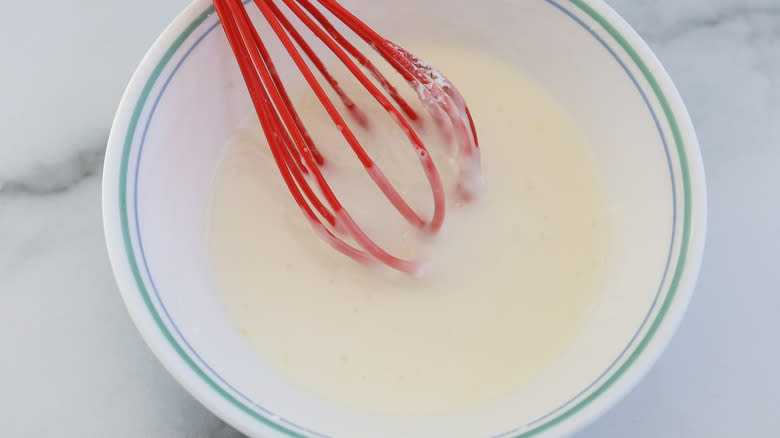 glaze in a bowl with whisk