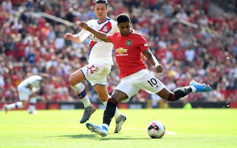 Marcus Rashford shoots as he is closed down by Martin Kelly - Credit: GETTY IMAGES