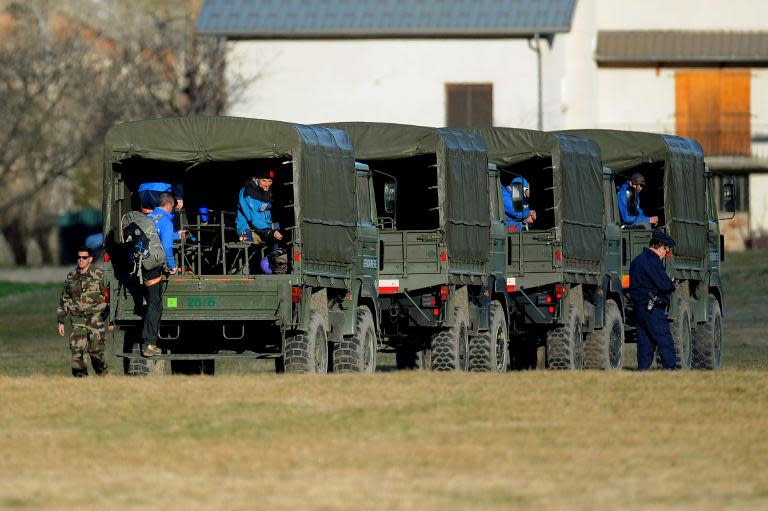 Military vehicles arrive ahead of operations at the site of the Germanwings Airbus A320 crash, in Seyne-les-Alpes on March 31, 2015