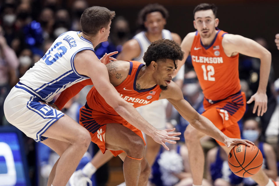 Duke forward Joey Baker (13) guards Clemson guard David Collins during the first half of an NCAA college basketball game in Durham, N.C., Tuesday, Jan. 25, 2022. (AP Photo/Gerry Broome)