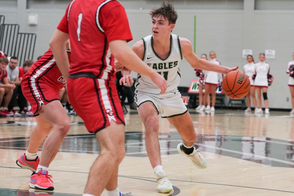 Zionsville Eagles Drew Snively (11) dribbles the basketball Tuesday, Feb. 6, 2024, during the game at Zionsville High School in Zionsville, Indiana. The Center Grove Trojans defeated the Zionsville Eagles 60-49.