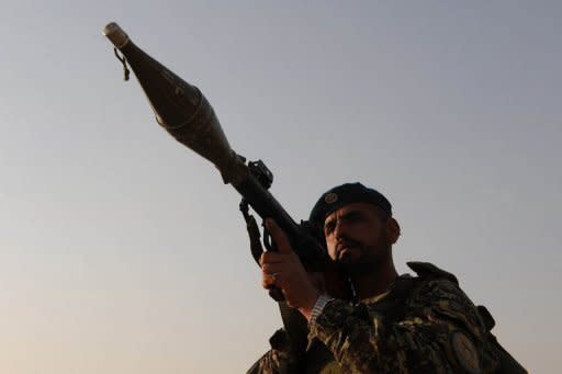 An Afghan National Army soldier holds a rocket-propelled grenade launcher as he keeps watch at the defence ministry in Kabul on March 28. A suicide bomber attacked foreign military forces in northern Afghanistan on Wednesday, killing at least 12 people including three international troops, officials said