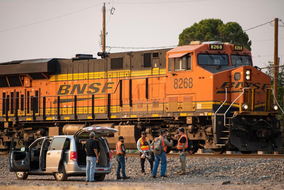 A crew works on a BNSF train after it stalled in the middle of Las Cruces, N.M., on Tuesday. The train blocked major crossings, including Picacho and Amador avenues, for about 3 hours.