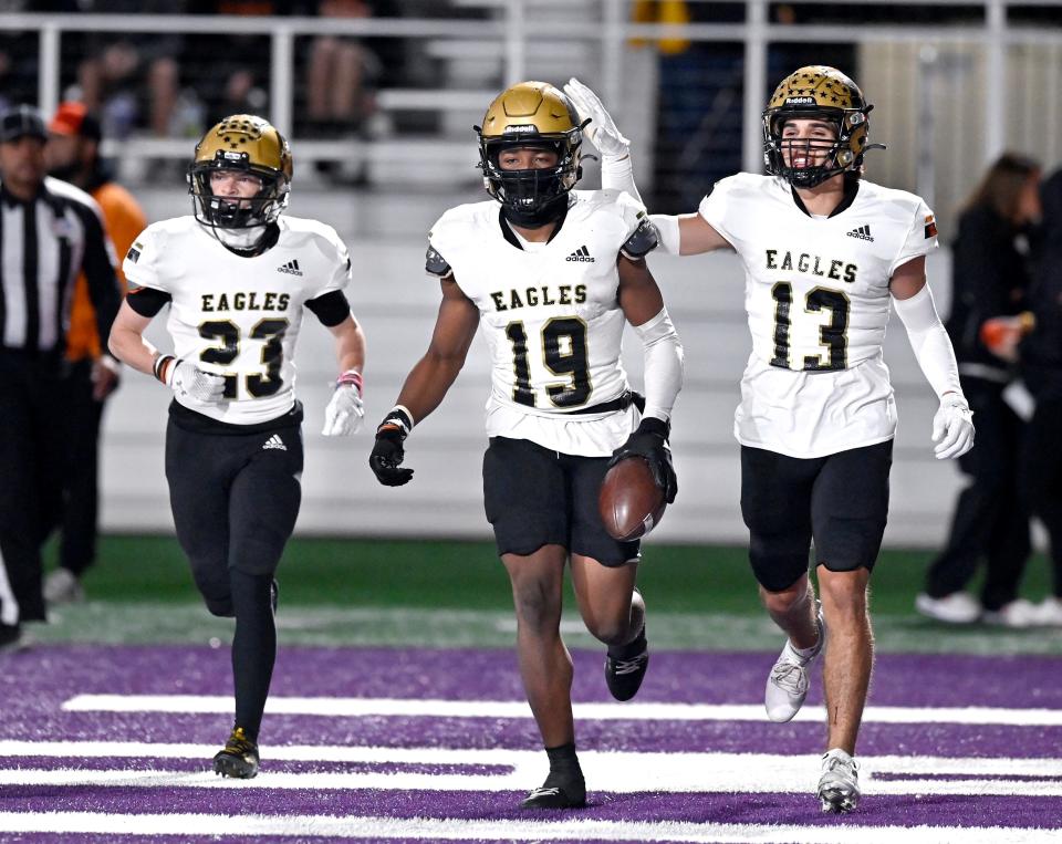 As Raiden Harris runs beside them in the end zone (left), Abilene High wide receiver Jackson Howle congratulates Ryland Bradford with a tap on the helmet after Bradford’s touchdown against Aledo Friday.