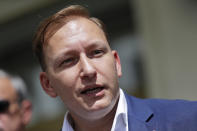 Andrei Dmitriyev speaks to journalists after he was registered as a candidate for the presidential elections in Minsk, Belarus, Tuesday, July 14, 2020. The election commission has cleared Belarusian President Alexander Lukashenko and four other candidates for running in a presidential vote in August, but denied registration to Lukashenko's two main aspiring challengers. (AP Photo/Sergei Grits)