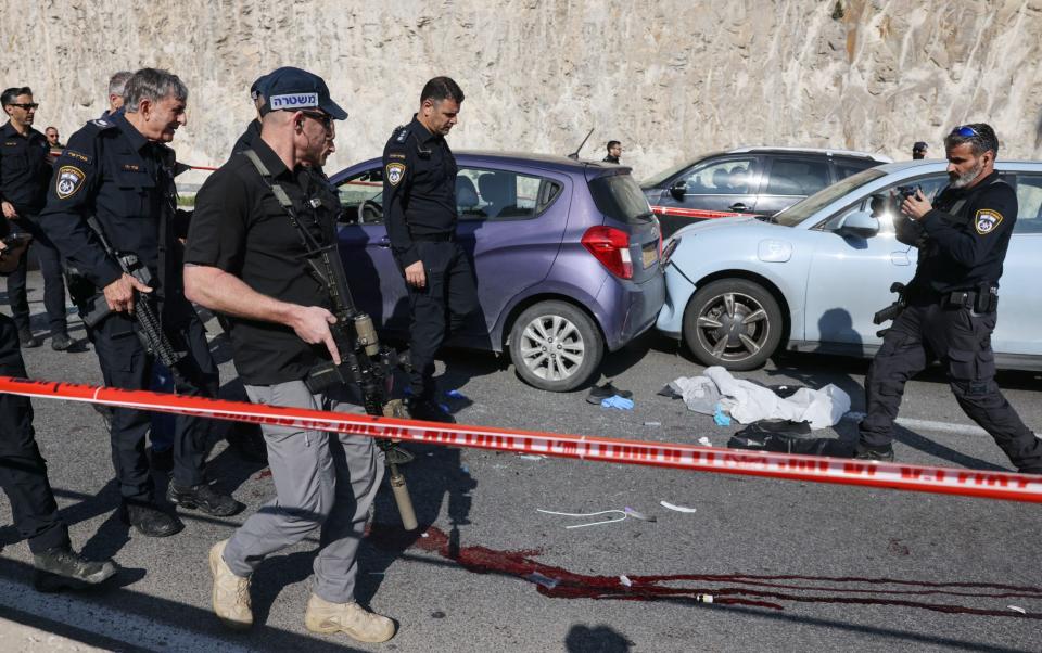 Israeli security forces inspect the scene of a shooting attack