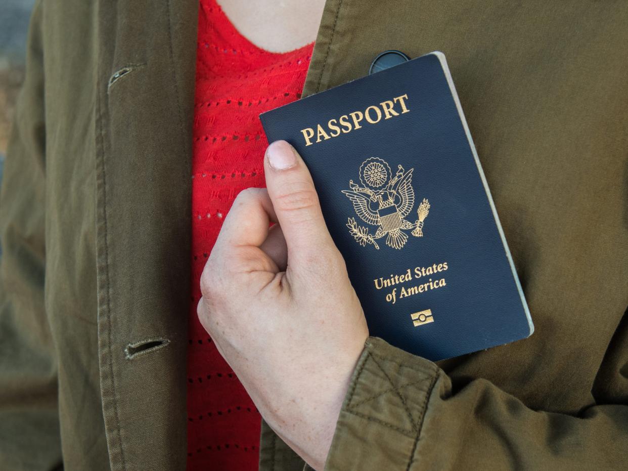 Close-Up Midsection Of Woman Holding Passport