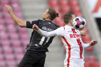 Bremen's Niclas Fuellkrug, left, and Cologne's Jannes Horn, right, challenge for the ball during the German Bundesliga soccer match between 1. FC Cologne and Werder Bremen in Cologne, Germany, Sunday, March 7, 2021. (Rolf Vennenbernd/dpa via AP)