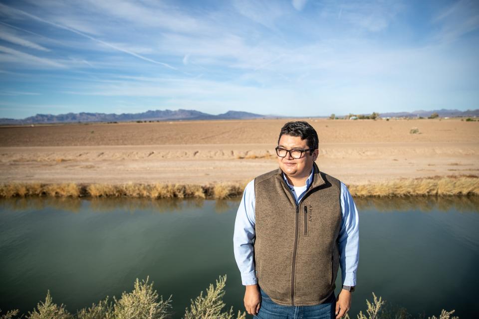 Joshua Moore, farm manager at Colorado River Indian Tribes Farms, poses for a portrait along a canal in Parker on Dec. 10, 2021.