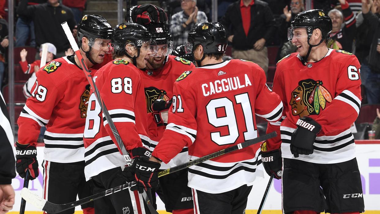 CHICAGO, IL - OCTOBER 27: (L-R) Jonathan Toews #19, Patrick Kane #88, Erik Gustafsson #56, Drake Caggiula #91 and Slater Koekkoek #68 of the Chicago Blackhawks celebrate after Caggiula scored against the Los Angeles Kings in the third period at the United Center on October 27, 2019 in Chicago, Illinois.  (Photo by Bill Smith/NHLI via Getty Images)