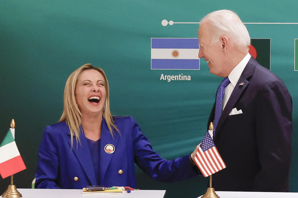 FILE - Italian Prime Minister Giorgia Meloni, left, and U.S. President Joe Biden react at the launch of the Global Biofuels Alliance at the G20 summit in New Delhi, India, Saturday, Sept. 9, 2023. When Giorgia Meloni took office a year ago as the first far-right premier in Italy's post-war history, concern was palpable abroad about the prospect of democratic backsliding and resistance to European Union rules. But since being sworn in as premier on Oct. 22, 2022, Meloni has confounded Western skeptics. (AP Photo/Evelyn Hockstein, Pool, File )