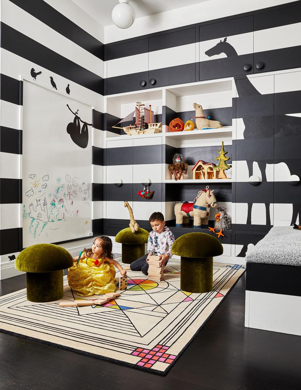 In the playroom, mushroom stools by Maison Gerard stand on a Renate Müller rug. The walls were custom painted.