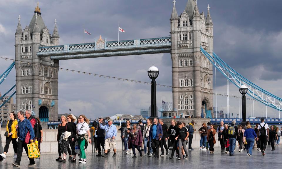People queue at the start of the more than four miles long line, near Tower Bridge (AP)