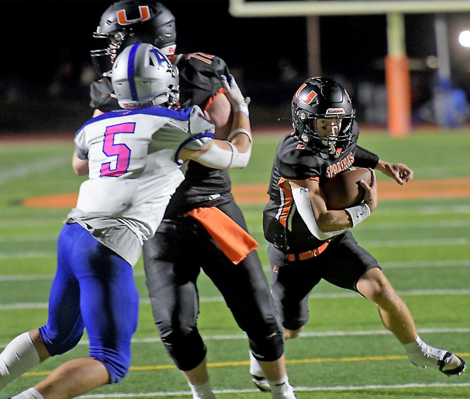 Uxbridge's Kellen LaChapelle finds running room, thanks to a block by teammate Nathan Noyes on Auburn's Nathan Cook.