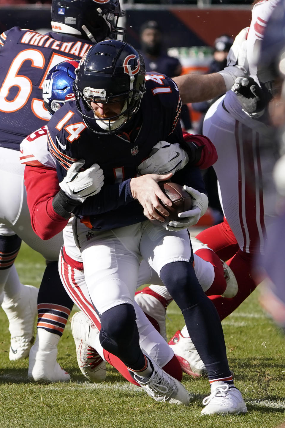 Chicago Bears quarterback Andy Dalton is sacked by New York Giants outside linebacker Lorenzo Carter during the first half of an NFL football game Sunday, Jan. 2, 2022, in Chicago. (AP Photo/David Banks)