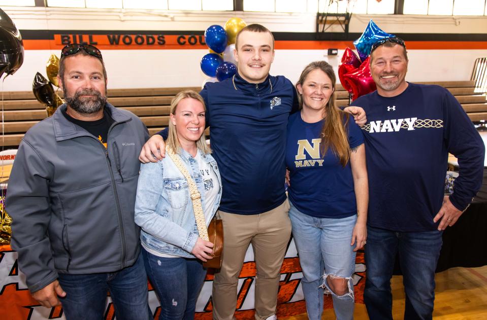 Andrew Zock, who signed with United States Naval Academy, third from left, poses with his dad Warren Zock, left, his step-mother Amber Zock, his mother Sarah Albright, second from right and his step-father Danny Albright, right, Wednesday afternoon, February 7, 2024. Hawthorne High School celebrated National Signing Day with seven of their football players signing letters of intent with colleges throughout the country. Head Football Coach Cornelius Ingram introduced all seven and spoke about their contributions to the team before they all signed. Que King signed with University of North Carolina at Pembroke, Demetri Perry signed with Fayetteville State University, Jamarion Davenport signed with Andrew College, Caleb Rollerson signed with University of Central Florida, Andrew Zock signed with United States Naval Academy, Earick Williams signed with Jackson State and Jordin Fluellen signed with University of North Carolina at Pembroke. [Doug Engle/Ocala Star Banner]2024