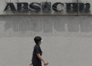 A man wearing a mask passes by the headquarters of broadcast network ABS-CBN Corp. on Wednesday May 6, 2020 in Manila, Philippines. Philippine church and business leaders expressed alarm Wednesday over a government agency’s shutdown of the country’s largest TV and radio network, which has been a major provider of news on the coronavirus pandemic. (AP Photo/Aaron Favila)