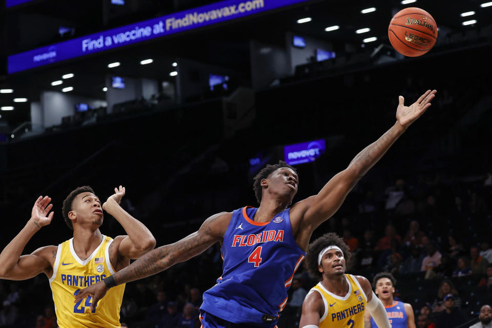 Florida forward Tyrese Samuel (4) reaches for the ball next to Pittsburgh forward William Jeffress (24) during the second half of an NCAA college basketball game in the NIT Season Tip-Off on Wednesday, Nov. 22, 2023, in New York. (AP Photo/Eduardo Munoz Alvarez)