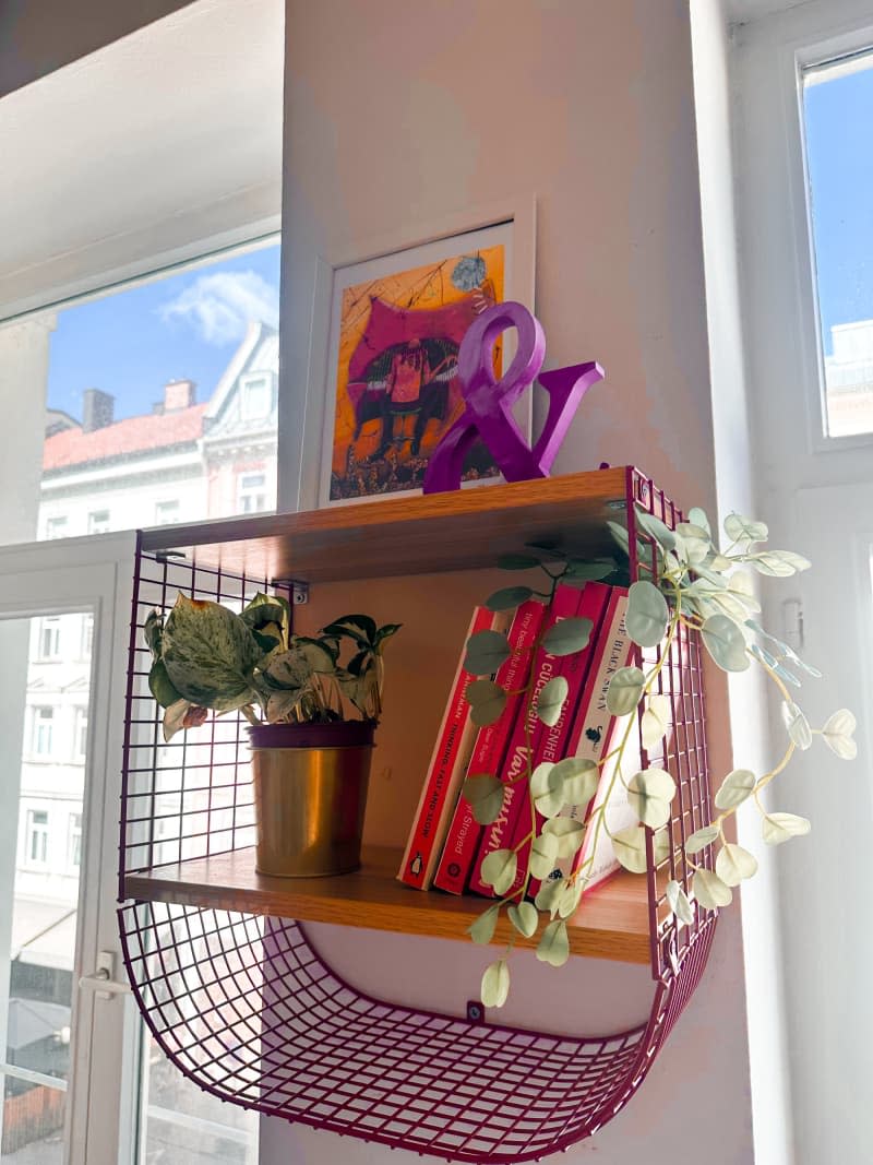 mesh metal curved red shelf with wood boards on wall