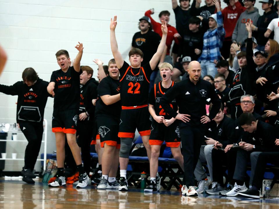 New Lexington's bench celebrates a 3-pointer during the third quarter of a 44-36 loss to West Muskingum on Friday night in Falls Township. The loss snapped the Panthers' 11-game win streak.