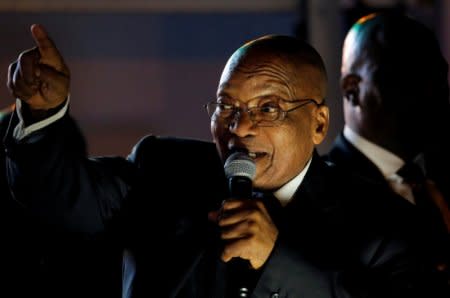 FILE PHOTO: South Africa's President Jacob Zuma celebrates with his supporters after he survived a no-confidence motion in parliament in Cape Town, South Africa, August 8, 2017.   REUTERS/Mike Hutchings/File Photo