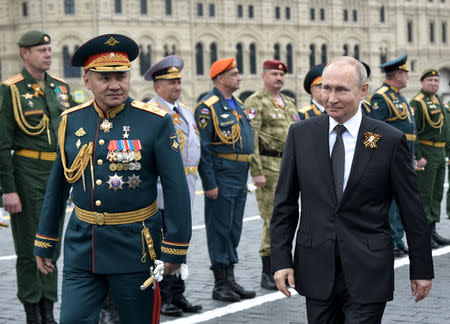 Russia's President Vladimir Putin (R) and Defence Minister Sergei Shoigu attend the Victory Day parade, which marks the anniversary of the victory over Nazi Germany in World War Two, in Red Square in central Moscow, Russia May 9, 2019. Sputnik/Alexei Nikolsky/Kremlin via REUTERS