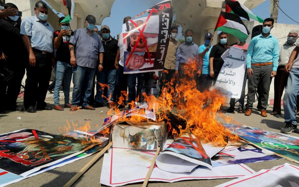 Palestinians burn pictures depicting President Donald Trump, Bahrain's King Hamad bin Isa Al Khalifa, Abu Dhabi Crown Prince Mohammed bin Zayed al-Nahyan and Israeli Prime Minister Benjamin Netanyahu during a protest in Gaza City - Reuters