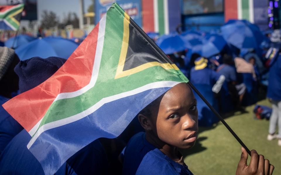 A child holding the South African flag