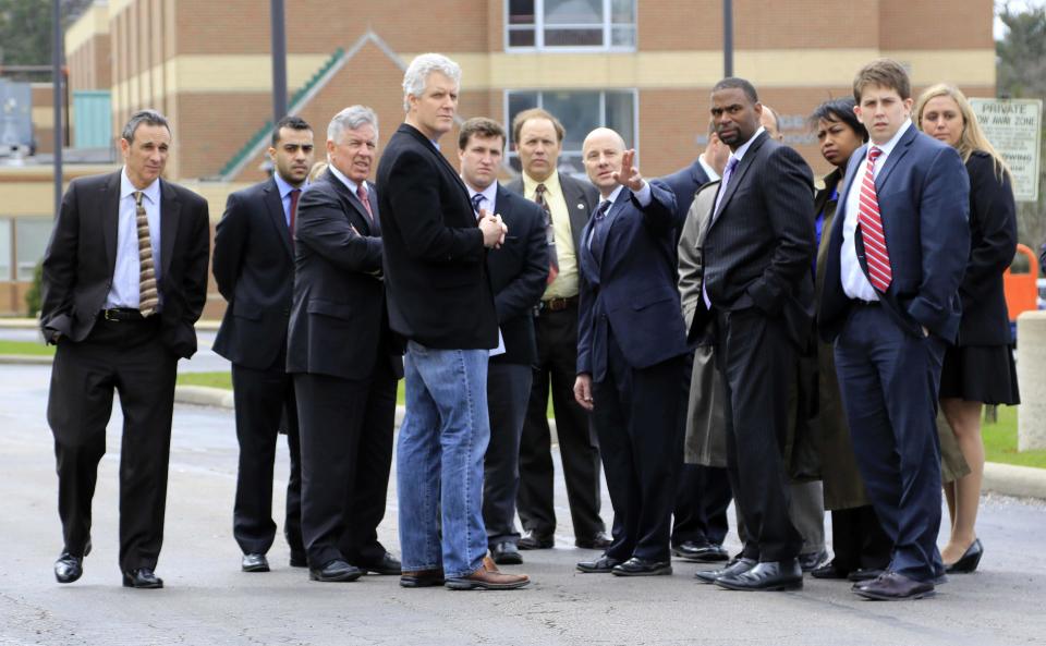 Cuyahoga County Common Pleas Judge John P. O'Donnell (4th L) reviews the crime scene with defense and prosecutors during the manslaughter trial for a police officer in Cleveland, Ohio April 10, 2015. Michael Brelo, 31, is accused of shooting dead two unarmed suspects as he stood on the hood of their car and fired through the windshield after a high-speed chase in November 2012. (REUTERS/Aaron Josefczyk)