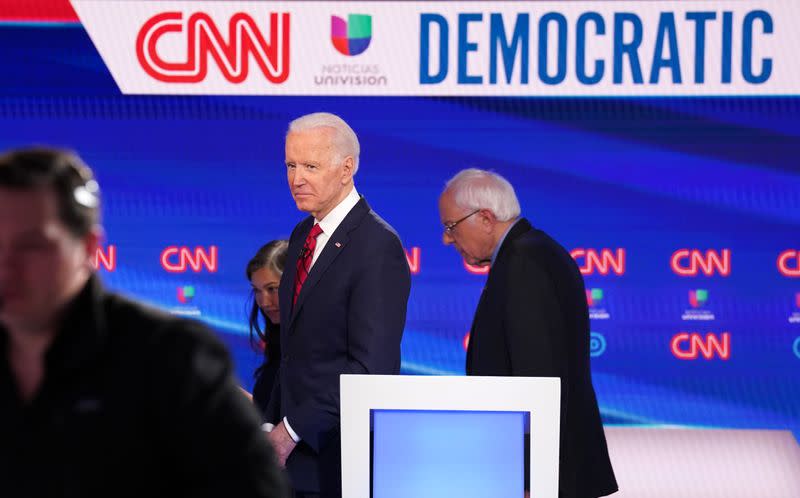 Democratic U.S. presidential candidates Senator Bernie Sanders and former Vice President Joe Biden during break at the 11th Democratic candidates debate of the 2020 U.S. presidential campaign in Washington