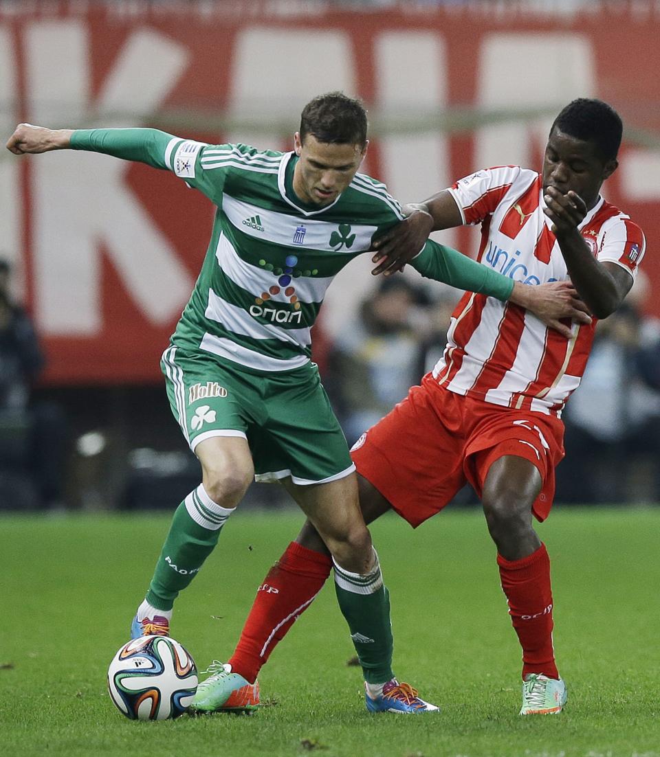 Olympiakos' Joel Campbell, right, and Panathinaikos' Marcus Berg fight for the ball during a Greek League soccer match at Georgios Karaiskakis stadium, in Piraeus port, near Athens, on Sunday, March 2, 2014. (AP Photo/Thanassis Stavrakis)