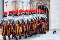 VATICAN CITY, VATICAN - DECEMBER 25: Swiss Guards perform ceremonial duties during the Christmas Day message 'urbi et orbi' blessing (to the city and to the world) delivered by Pope Benedict XVI from the central balcony of St Peter's Basilica on December 25, 2012 in Vatican City, Vatican. (Photo by Franco Origlia/Getty Images)